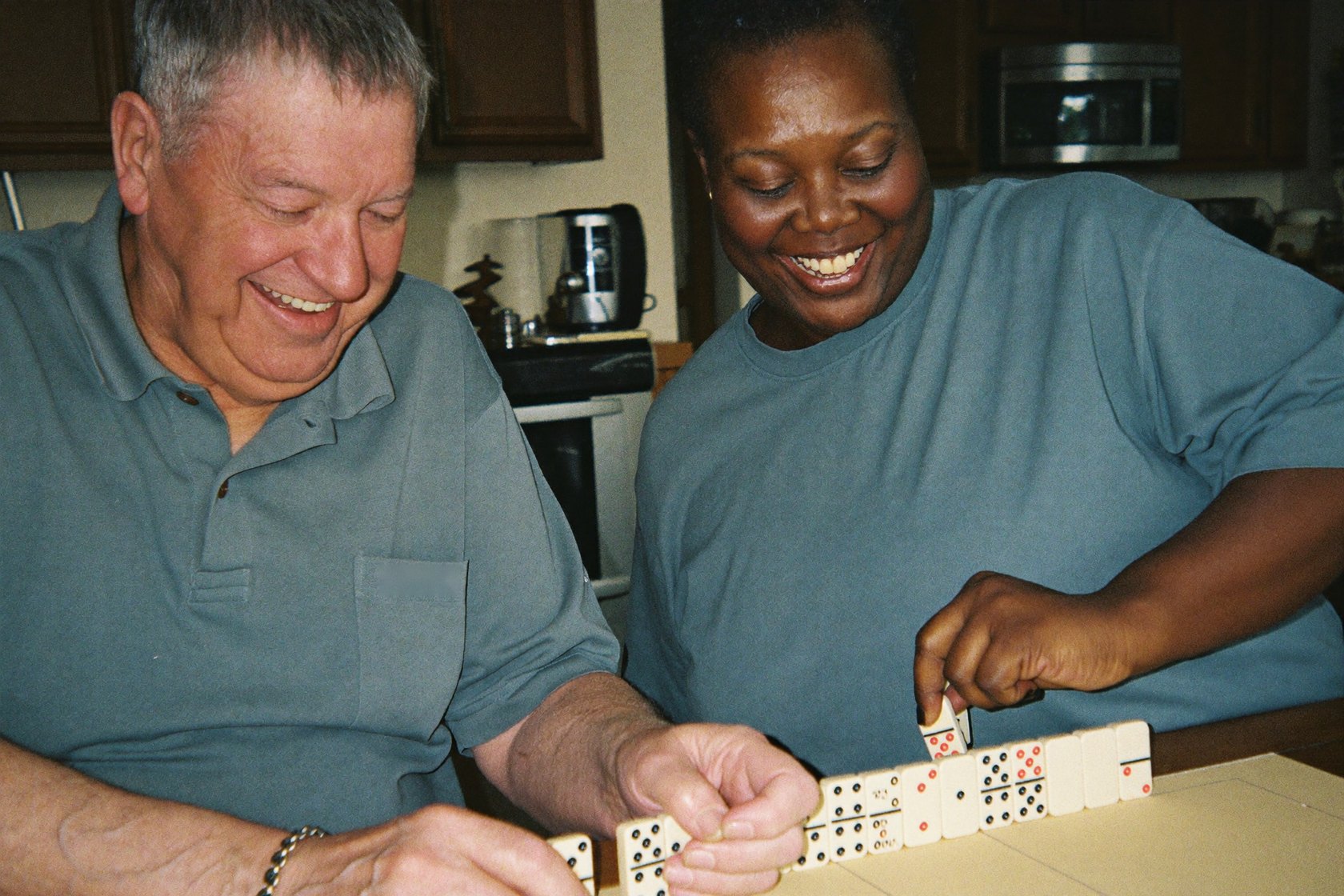 A caregiver sharing breakfast with a senior couple